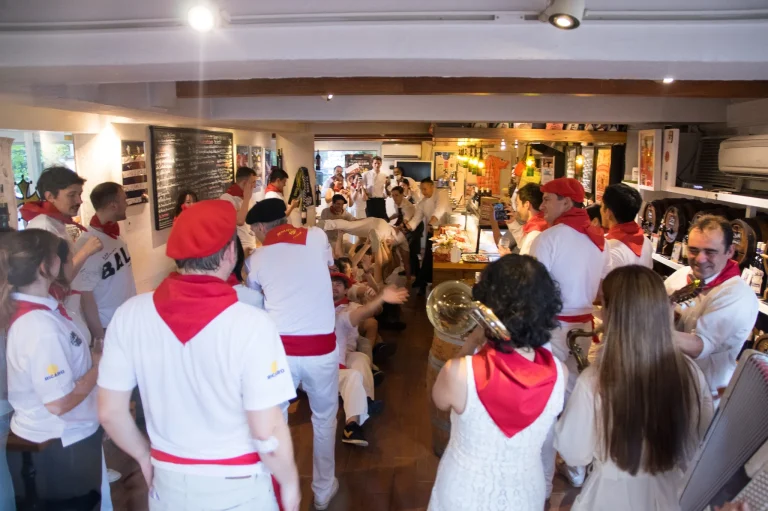 Guests in white and red feria colours gather around the bandas during the All France Rugby Club Feria Experience in Tokyo.